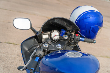 View of the fuel tank and steering wheel of a motorcycle with mirrors. Helm on the steering wheel