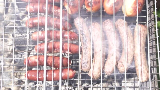 sausages and cevapcici fried meat grilled on an iron grate