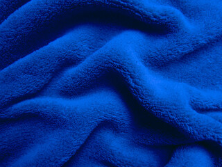 Fototapeta na wymiar Blue pile fabric draped with pleats.
