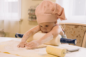 Little girl cooks at home in the kitchen