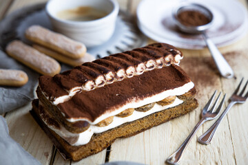 Tiramisu. Traditional italian dessert on wooden background. coffee break