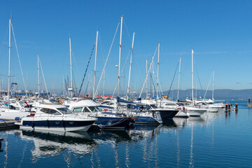 Fototapeta premium sailing and motor yachts in the seaport in bright sunny weather
