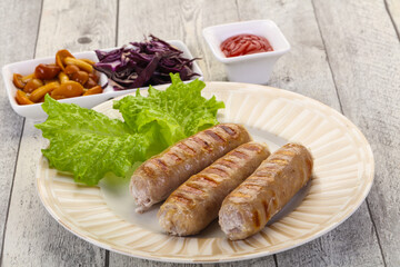 Grilled sausages served mushrooms and cabbage