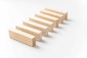 wooden bars lie on a light background. Selective focus