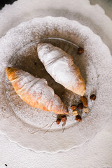 croissants sprinkled with icing on the plate