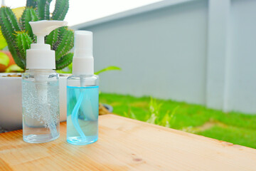 Alcohol gel and alcohol spray on green grass background.Hygiene, coronavirus concept. Prevent the spread of germs and bacteria and uniquely earn coronavirus using covid 19.Close up.
