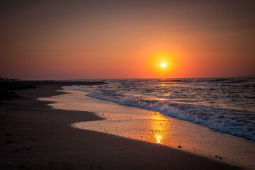 Orange sunset over the city beach