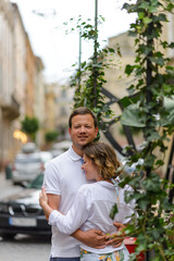 Two lovers hug on the streets of the old city during a date.