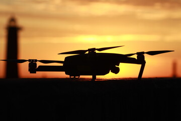 Fototapeta na wymiar Silhouette of a parked drone at sunrise