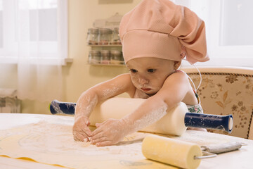 Little girl cooks at home in the kitchen