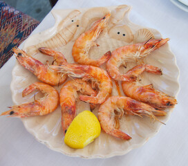 fresh grilled shrimps with lemon served on a plate