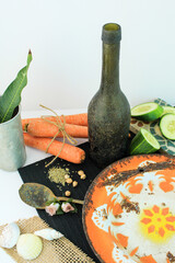 Vintage scene old dish with carrot wine bottle