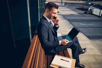 Young brunette male with documents sitting and talking