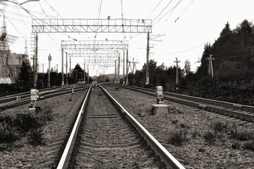 Railway rails extending into the distance. Black and white photography