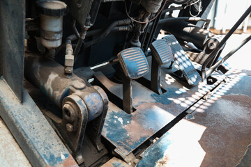 Electric forklift in warehouse from the inside, pedals