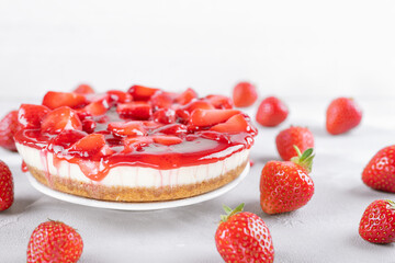cheesecake with strawberry and fresh berries on gray table and white background