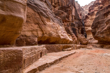 
The road to the main facade of Petra among the high red cliffs in Jordan.