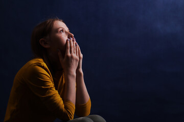 Teen girl sitting hugging his hands. Adolescent psychological and social problems.