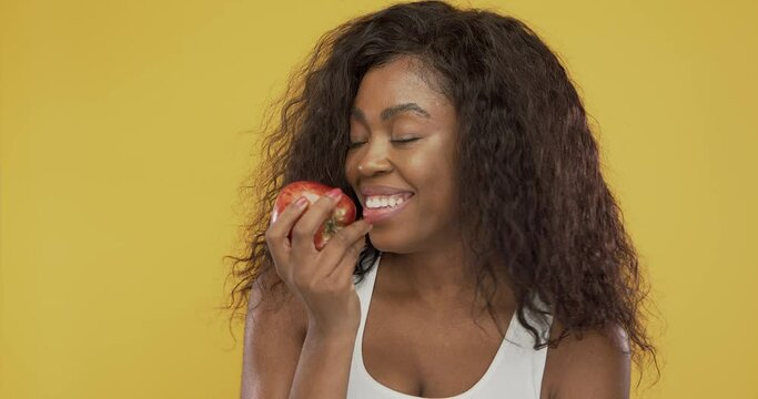 Black woman eating fresh apple