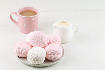 White and pink marshmallows, milk and cappuccino. Sweets.