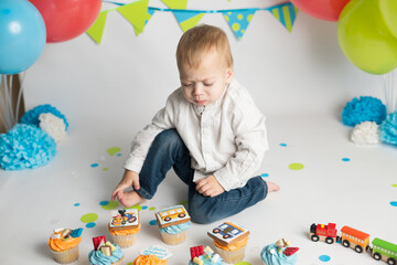 birthday boy with festive cupcakes in the form of a locomotive