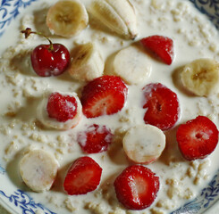 healthy breakfast - porridge with fruit strawberry, banana and cherry