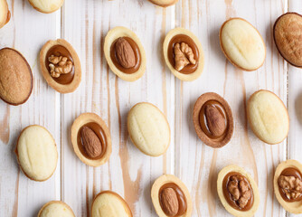 Homemade Russian nuts with condensed milk and mascarpone on a light blue background, wafer napkin. Cut nuts with condensed milk. Bitten goodies for tea. Condensed Nuts