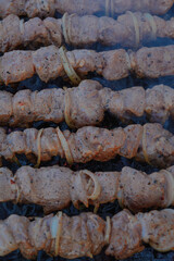 Fry kebabs mounted on skewers. Below are hot charcoals.