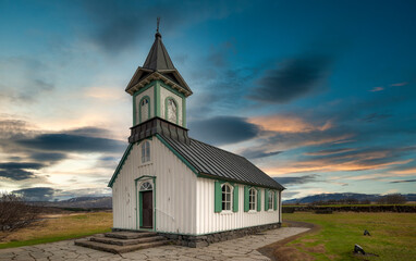 Fototapeta premium thingvellir church, steep valley formed by the separation of two tectonic plates, with rocky cliffs and fissures. Selfoss