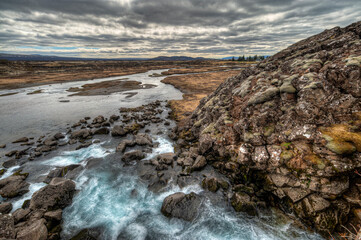thingvellir, steep valley formed by the separation of two tectonic plates, with rocky cliffs and fissures. Selfoss