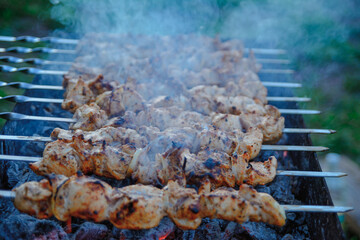 Fry kebabs mounted on skewers. Below are hot charcoals.