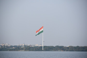 Indian national flag waving in the wind at Hussain Sagar Lake, Hyderabad, Telangana, India.