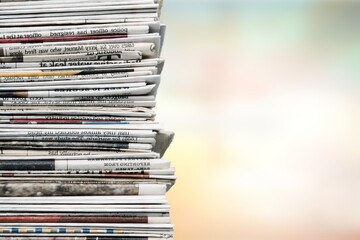Pile of fresh newspapers on a blur background