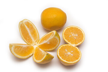 Orange fruit with orange slices and leaves isolated on white background.