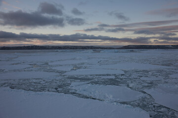 Antarctica landscape with ice and icebergs at sunset on a winter day