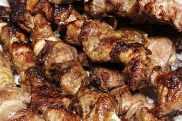 Grilled kebab. Roasted meat with onions. Background from food. Pork