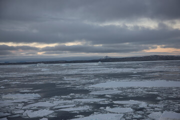 Antarctica landscape with ice and icebergs at sunset on a winter day