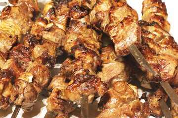 Grilled kebab. Roasted meat with onions. Background from food. Pork