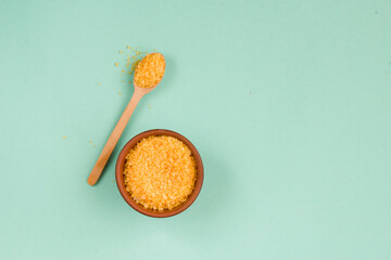 Cosmetic bath salt, grape gomaj for the face, coffee scrub for the body on a mint background. Spa...