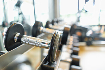 Fitness club weight training equipment gym modern interior , Barbells of different weight on rack.