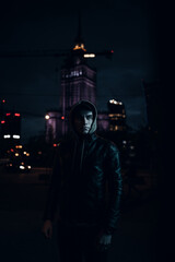 Naklejka premium Portrait of stylish man on night city background pose to camera Young man on urban street at nigh