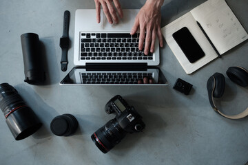 top view of creative photographer using graphic tablet on work table.