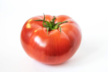 ripe juicy tomato on a white background close up