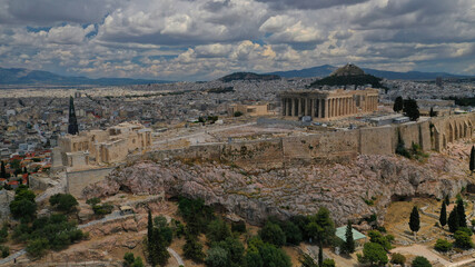 Aerial drone photo of Acropolis of Athens in Attica, Greece, with the Parthenon Temple on top of the hill during a cloudy spring day