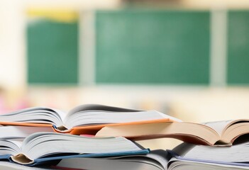 Open books collection on a school board background.