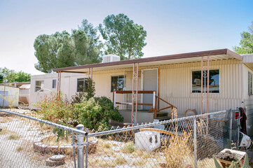 Trailer in need of repairs with overgrown weeds and a lot of junk in the yard - Mobile Home Investment - Cash returns - Low Income Housing
