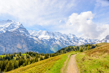 Obraz premium Crossing the Alps. Hiking trail in the Alps.