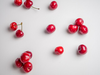 Naklejka na ściany i meble Sweet red cherries on white