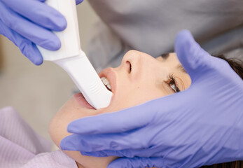 Crop dentist examining teeth of patient