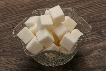 Refined white sugar cubs in the bowl